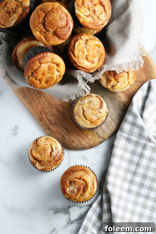 A spread of gorgeous Pumpkin Cream Cheese Swirl Muffins, perfect for any fall celebration, including Christmas or Thanksgiving desserts.