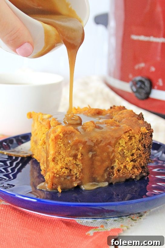Warm Crock Pot Pumpkin Bread Pudding drizzled with caramel sauce, ready to serve as a comforting fall dessert.