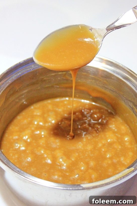 Prepping the rich, spiced pumpkin mixture for a decadent slow cooker bread pudding custard.