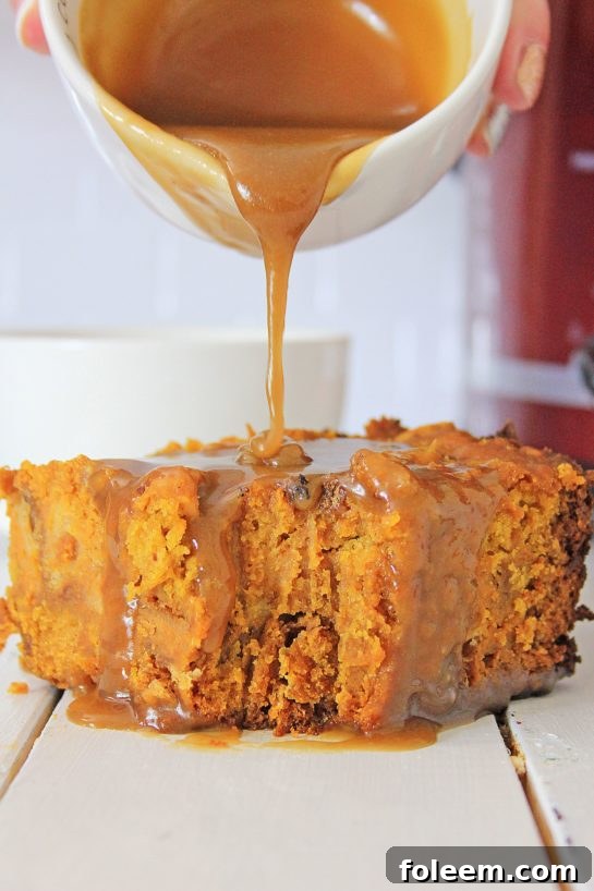 Luxurious caramel sauce being drizzled generously over warm Crock Pot Pumpkin Bread Pudding.