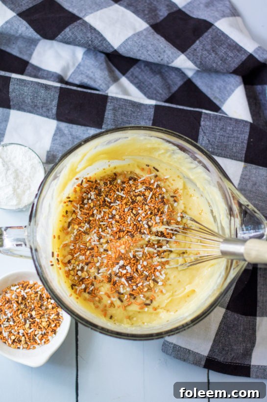 Adding fall-colored sprinkles to the batter for a festive and fun Fall Confetti Sweet Bread.