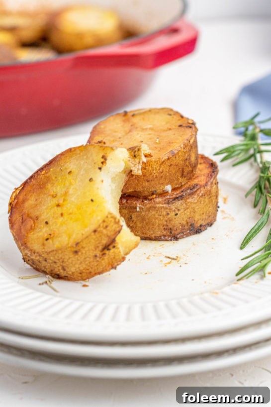 Close-up of baked melting potatoes in a cast iron skillet, showing crispy edges and tender texture
