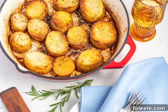 A serving of melting potatoes with fresh herbs, showcasing their inviting texture