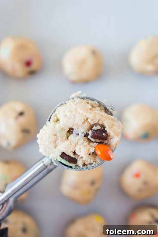Scooping out the dough for Edible Cookie Dough Bombs recipe