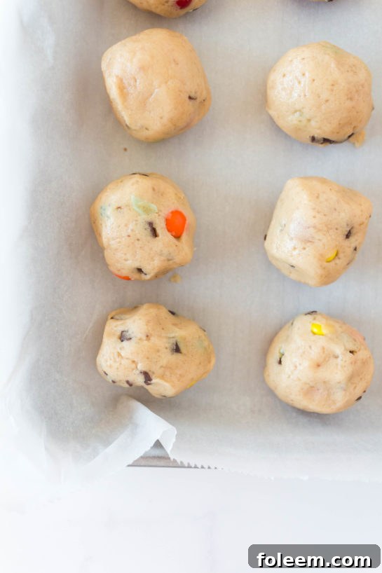 Close up of the dough balls being added to the baking tray for Edible Cookie Dough Bombs recipe