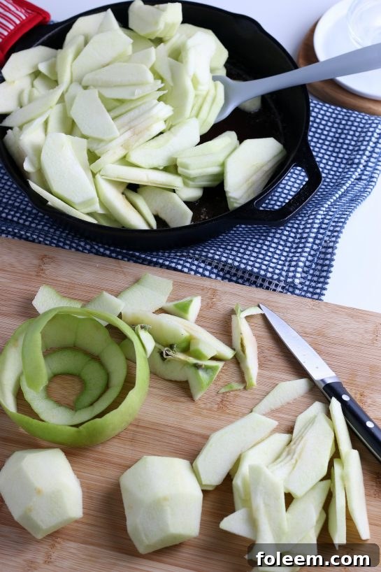 Close-up of hands peeling fresh apples, preparing them for the easy fried apples recipe.