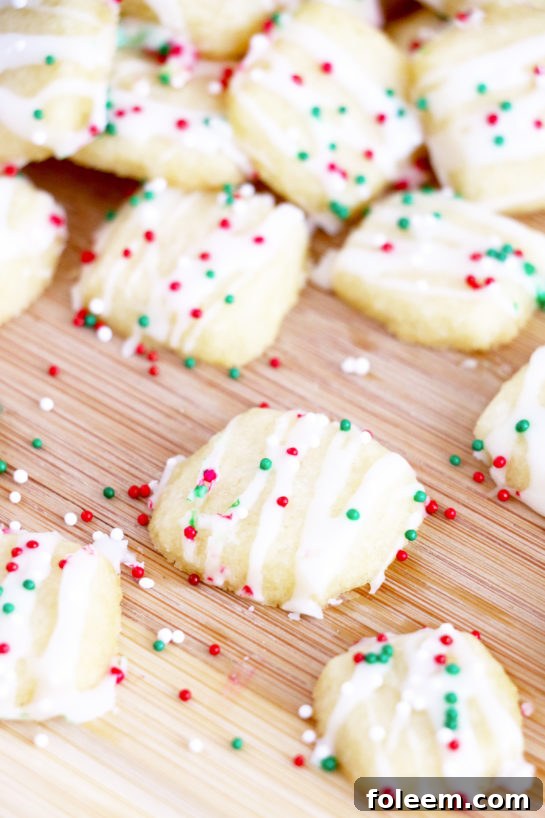 A vibrant display of iced Christmas Sugar Cookie Bites, ideal for holiday cookie trays or as thoughtful edible gifts.