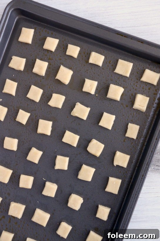 The neatly arranged dough pieces on the baking sheet, ready to be baked into Christmas Sugar Cookie Bites.