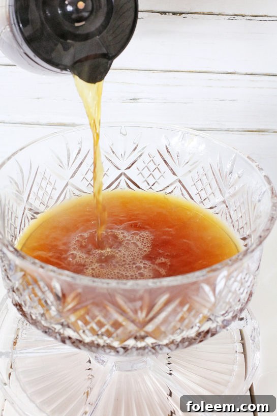 Brewed coffee being poured into a large mixing bowl.