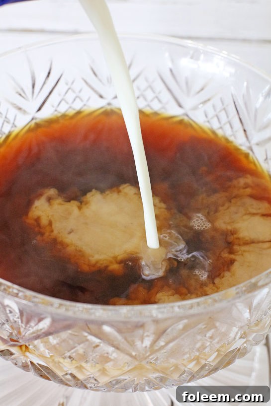 Vanilla coffee creamer being added to freshly brewed coffee.