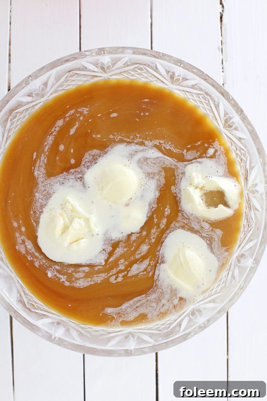 Scoops of coffee ice cream being added to the coffee and creamer mixture.