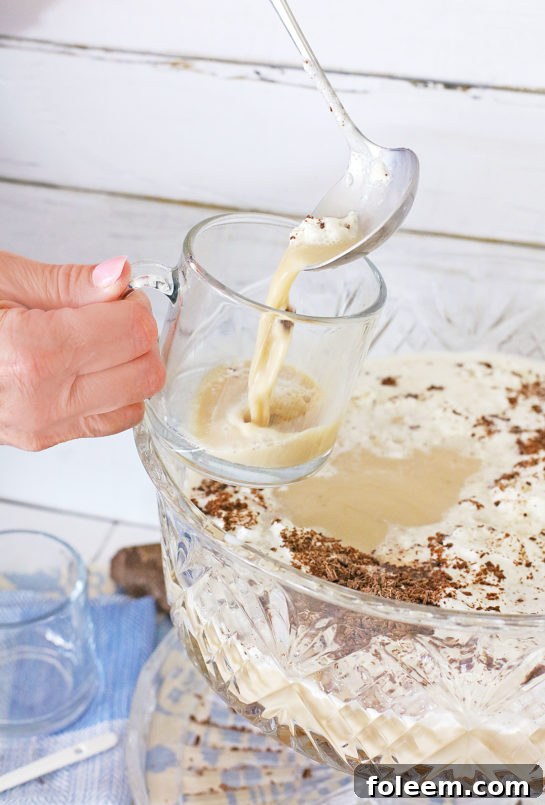 Serving coffee punch from a punch bowl into individual elegant glasses.