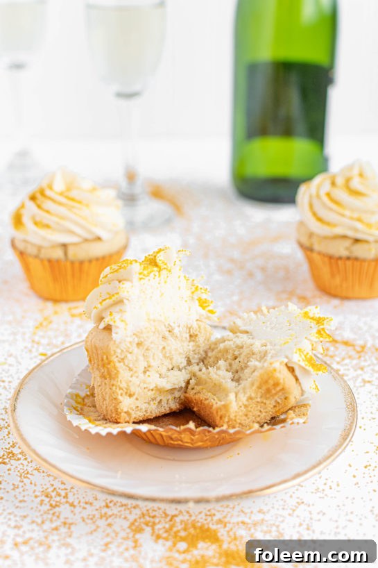 An inviting close-up of an open Champagne Cupcake, highlighting the light, airy texture and rich frosting, making it irresistible.
