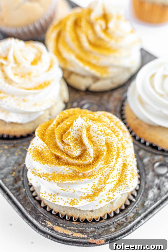 Beautifully decorated Champagne Cupcakes for a New Year's Eve party or Mother's Day brunch, accented with festive gold sprinkles.