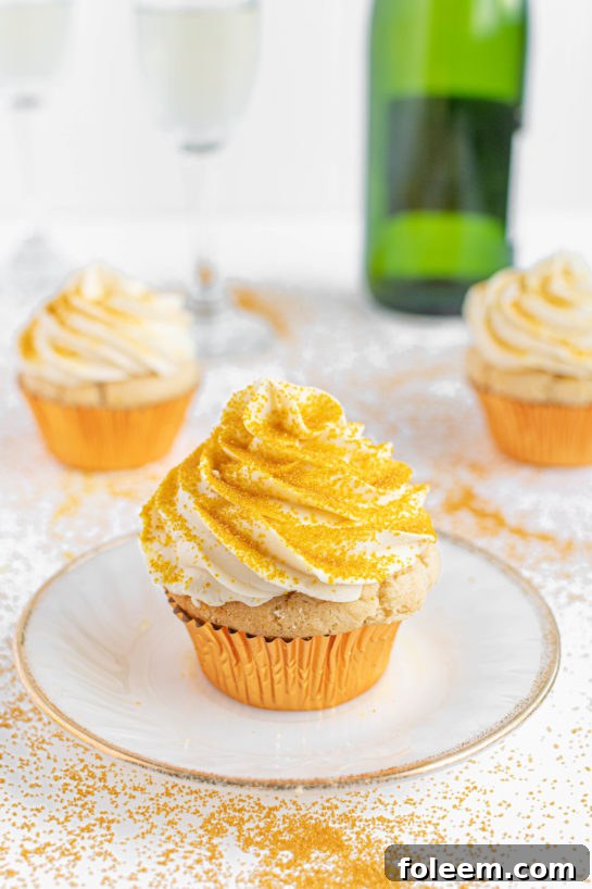 Plated Champagne Cupcakes, beautifully garnished with gold sprinkles, ready for a New Year's Eve celebration or a chic Mother's Day gathering.