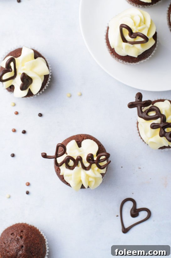 Overhead view of a tray of completed Valentine's Day Lover's Chocolate Cupcakes, showcasing their intricate details.