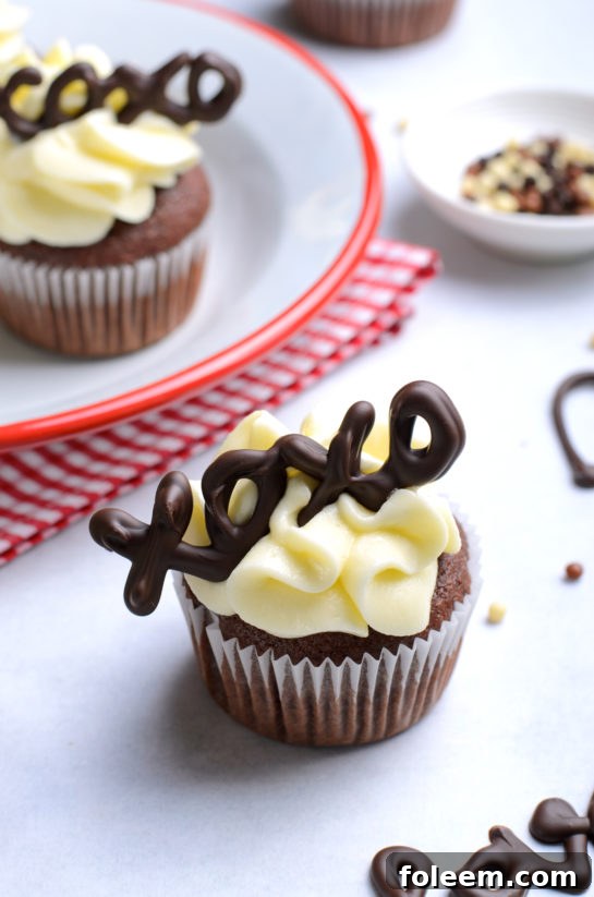 Beautifully frosted Valentine's Day Lover's Chocolate Cupcakes adorned with elegant chocolate lettering.