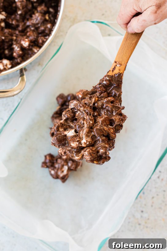Pouring the candy into the pan to make the Valentine's Day Best Rocky Road recipe