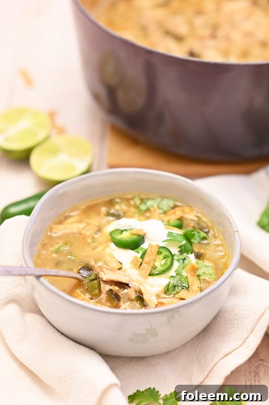 Comforting White Chicken Chili recipe, garnished with fresh cilantro, a delicious and easy meal perfect for game day, holidays, or a simple weeknight dinner.
