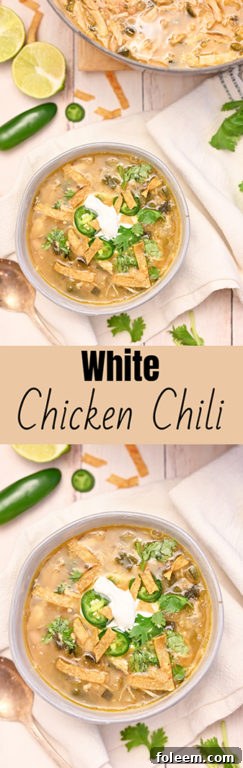 A close-up shot of a steaming bowl of White Chicken Chili, richly garnished with fresh cilantro and a lime wedge, ready to be enjoyed as a comforting meal.