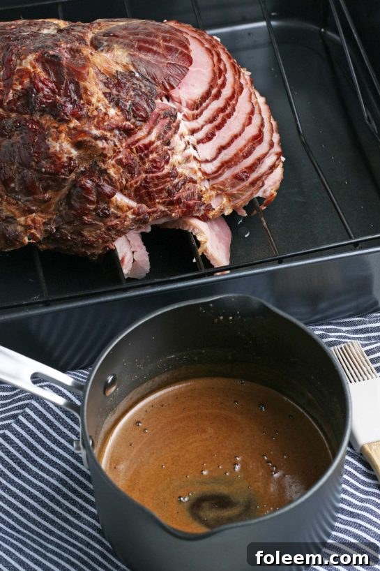 A close-up shot of the saucepan containing the whisked glaze ingredients, simmering gently on the stove, beginning to thicken.
