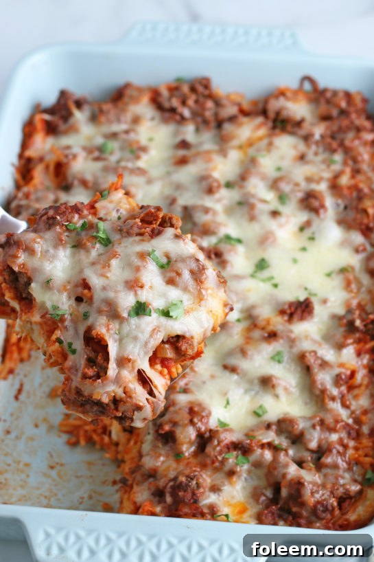 A delightful glimpse into the pan of our baked spaghetti casserole, showing its creamy, cheesy layers ready to be served and savored for dinner.
