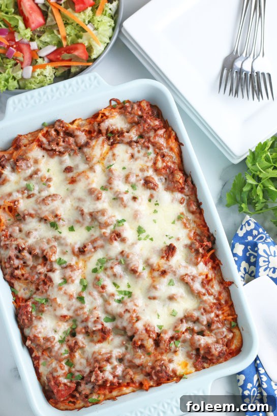 A stunning view of the Baked Million Dollar Spaghetti casserole, freshly out of the oven, with its bubbly, golden-brown topping, ready for a delicious meal.