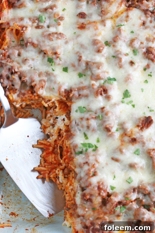 A glorious close-up of the finished Baked Million Dollar Spaghetti casserole, still in the baking dish, invitingly ready for serving.