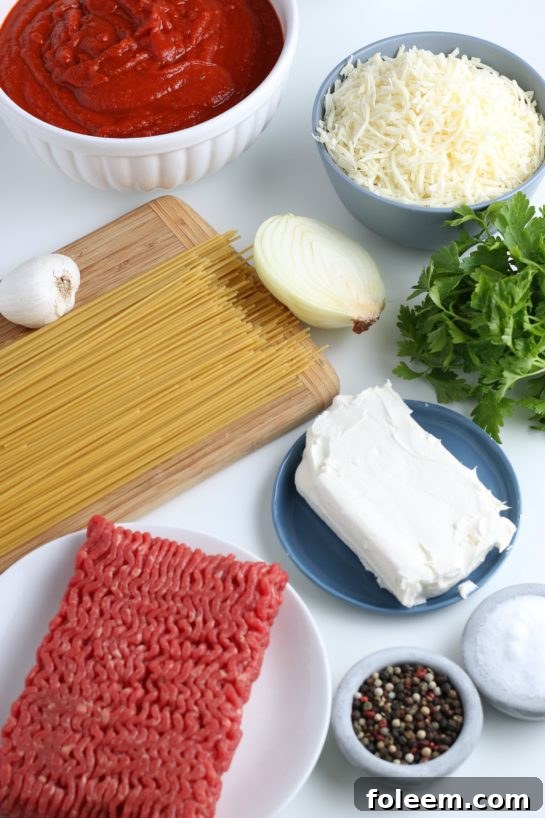 All the fresh ingredients for making our delicious baked spaghetti recipe are neatly laid out on a counter, ready for preparation.