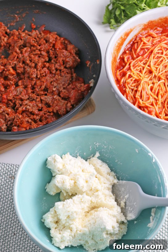The creamy cheese mixture, a key component, is meticulously prepared before being layered into the baked spaghetti casserole.