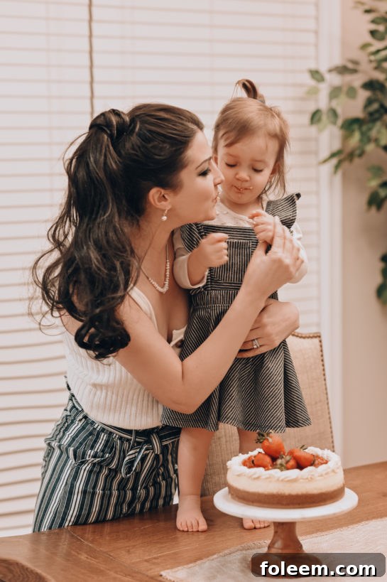 Another perspective of a child enjoying the taste of the freshly made Strawberry Topped New York-Style Cheesecake