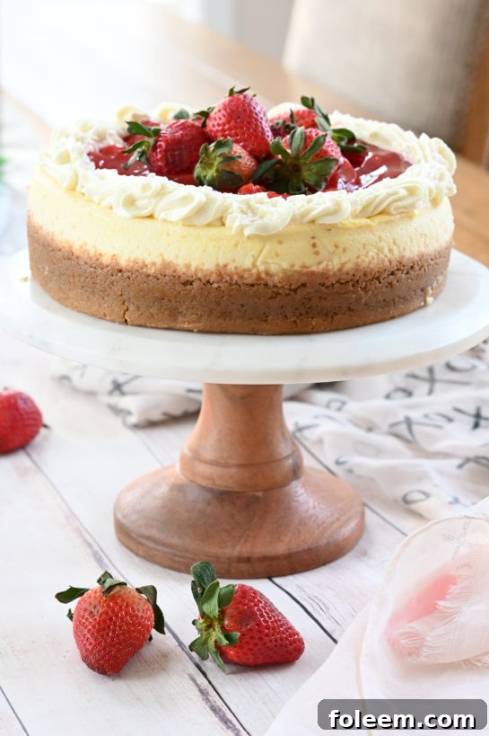 Final detailed shot of the Strawberry Topped New York-Style Cheesecake, garnished with fresh strawberries