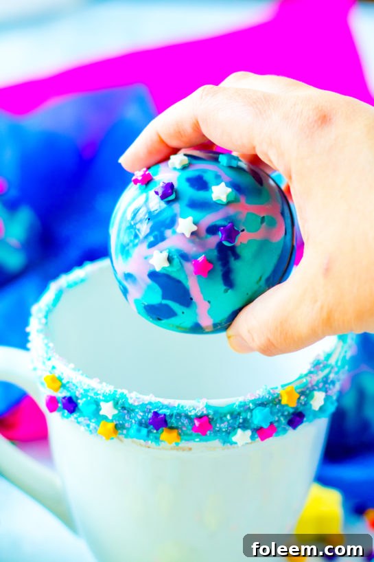 Colorful Galaxy Hot Chocolate Bombs filled with hot cocoa mix, marshmallows, and sprinkles, ready for a party.