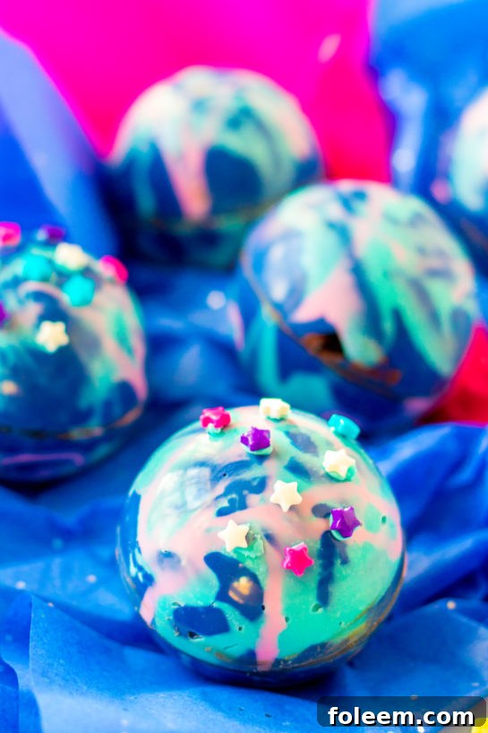 Close-up shot of finished Galaxy Hot Chocolate Bombs, ready to be served.