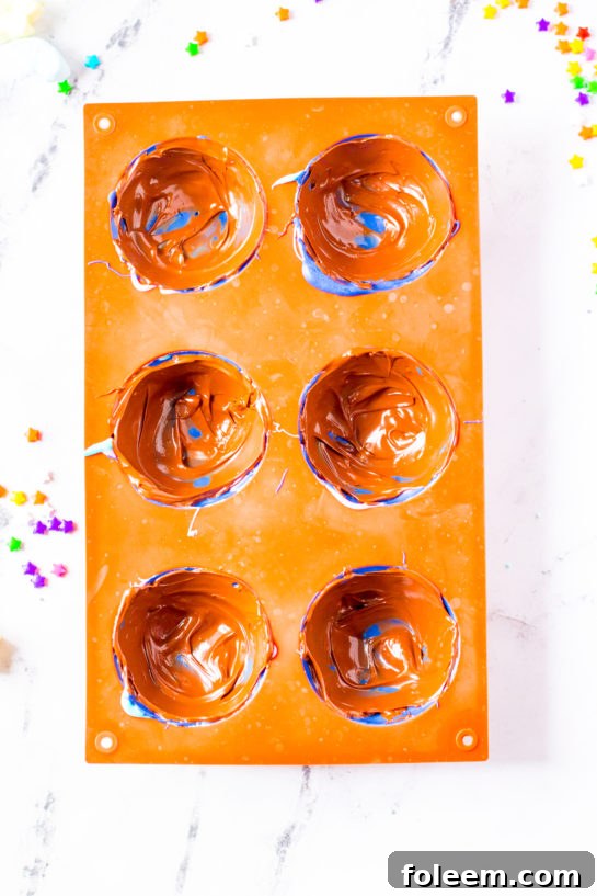 Overhead shot of silicone half-sphere molds, ready for chocolate.