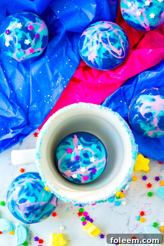 Dropping a finished Galaxy Hot Chocolate Bomb into a mug.