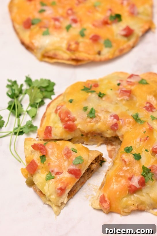 This Mexican Pizza recipe is a quick and easy dinner idea for Mexican night, taco Tuesday, or Cinco de Mayo! The whole family will love these!