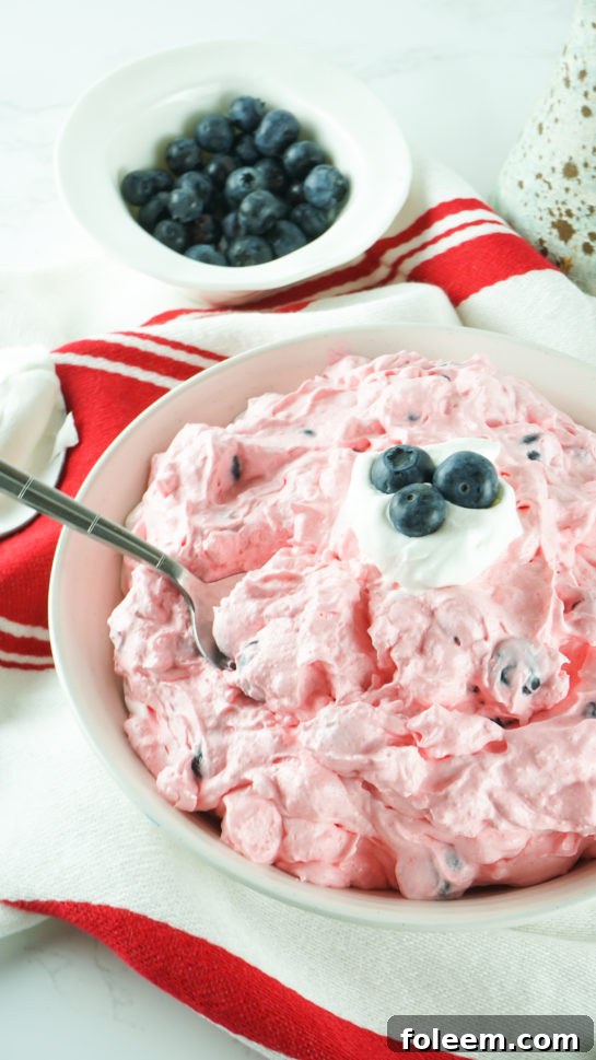 Vibrant Red White and Blue Fluff Salad in a large bowl, ready to serve at any occasion.