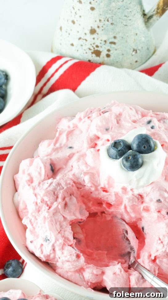 Large serving of Patriotic Red White and Blue Fluff Salad, perfect for gatherings.