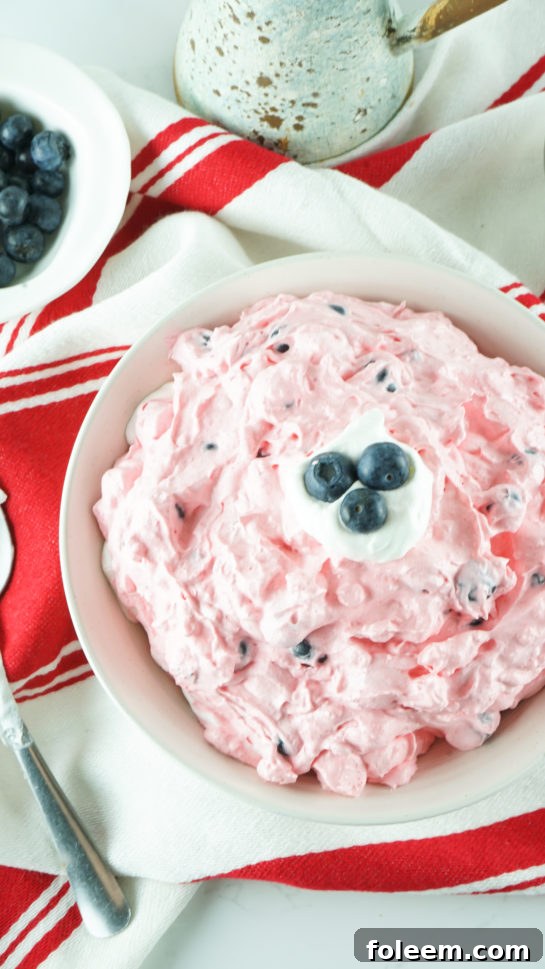 A close-up shot of the Easy Patriotic Red White and Blue Fluff Salad, highlighting its fluffy texture.