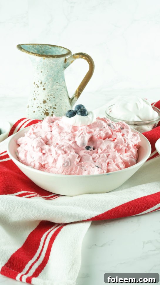 Beautifully presented Easy Patriotic Red White and Blue Fluff Salad for any picnic or potluck event.