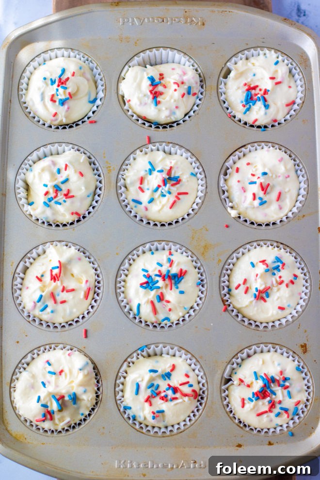 Red, White, and Blue Mini Cheesecakes Recipe ready to go in the oven with the sprinkles on top