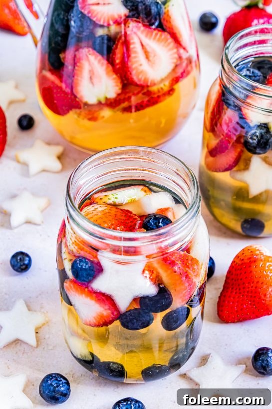 Enjoy my Patriotic Sangria recipe this summer to enjoy a cocktail while beating the heat at the same time! With fresh blueberries, strawberries, white grape juice, brandy, and wine, it's perfect for Flag Day, 4th of July or Memorial Day holiday!
