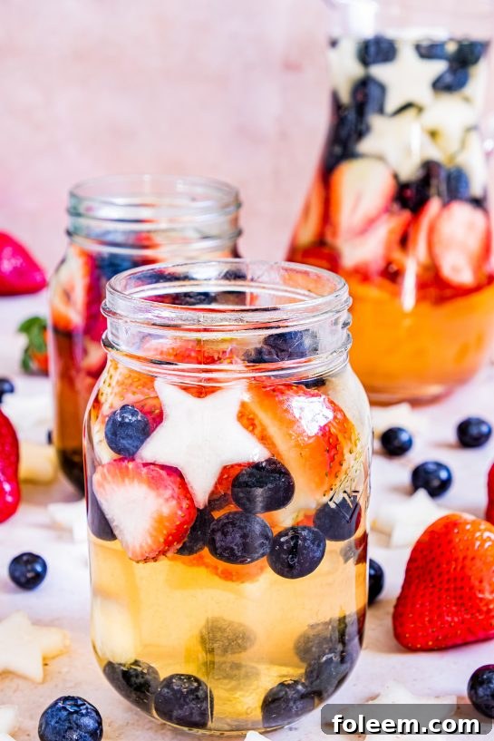 Enjoy my Red, White & Blue Sangria recipe this summer to enjoy a cocktail while beating the heat at the same time! With fresh blueberries, strawberries, white grape juice, brandy, and wine, it's perfect for Flag Day, 4th of July or Memorial Day!