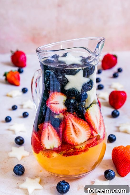 Sip on my Patriotic Sangria recipe this summer to enjoy a cocktail while beating the heat at the same time! With fresh blueberries, strawberries, white grape juice, brandy, and wine, it's perfect for 4th of July or Memorial Day!