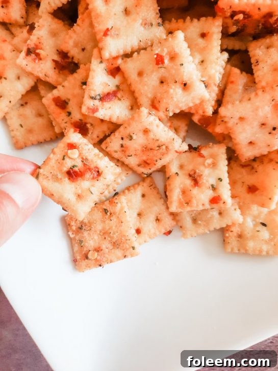 A generous serving of Spicy Alabama Fire Crackers in a bowl, highlighting their vibrant seasoning.