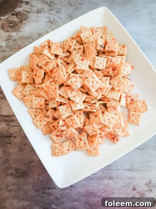 A large serving bowl filled with Spicy Alabama Fire Crackers, showcasing their appealing golden-brown color and seasoning.