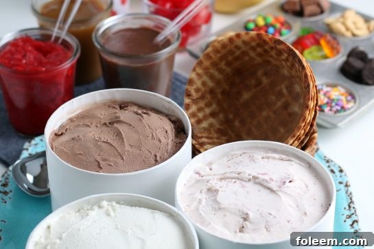 A variety of ice cream flavors and many topping options laid out for a budget-friendly DIY sundae bar.