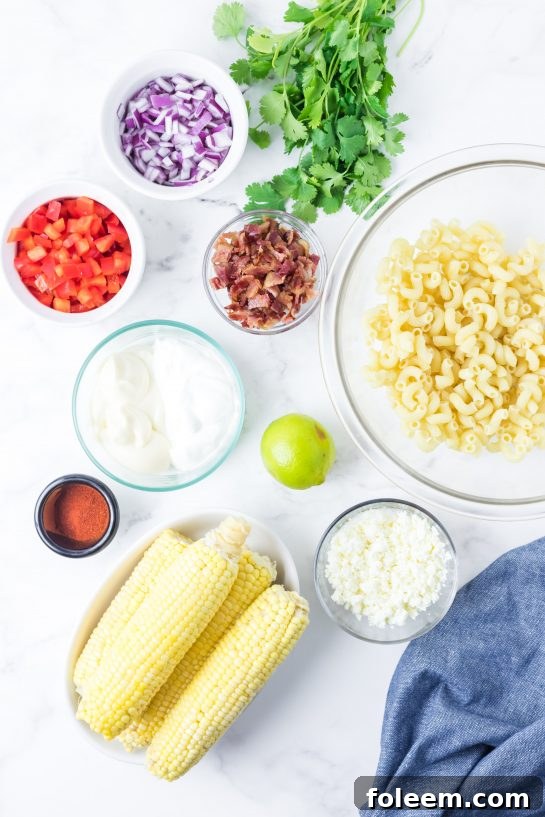 Fresh ingredients laid out for Mexican Street Corn Pasta Salad recipe preparation.