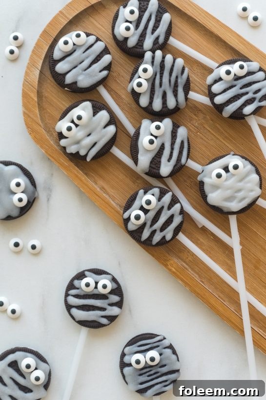 Adorable Halloween Mummy Oreo Pops with candy eyes, perfect for a spooky treat.